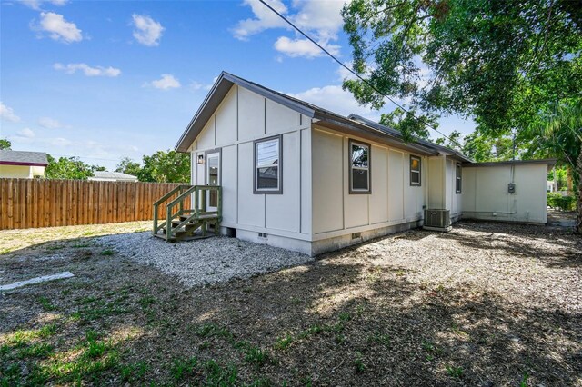 1750 Dayton St S, Saint Petersburg, FL 33712 - rear view of property featuring crawl space, board and batten siding, and central AC unit