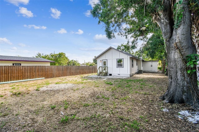 1750 Dayton St S, Saint Petersburg, FL 33712 - rear view of house with a fenced backyard, board and batten siding, and crawl space