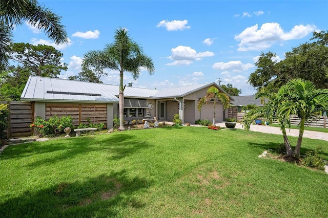 2320 James Ln, Sarasota, FL 34231 - view of front facade with an attached garage, a metal roof, driveway, and a standing seam roof