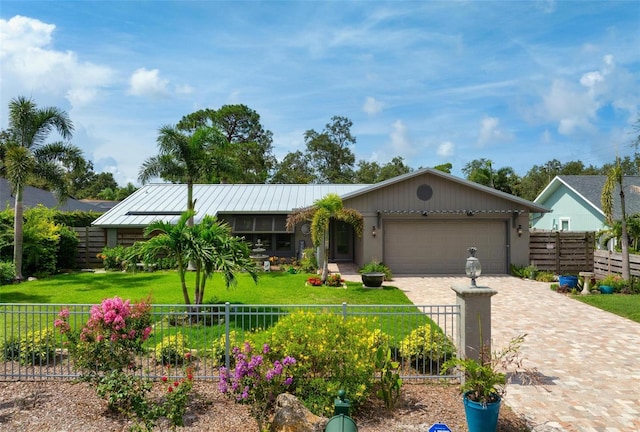 2320 James Ln, Sarasota, FL 34231 - view of front of home with a fenced front yard, an attached garage, decorative driveway, a standing seam roof, and a metal roof