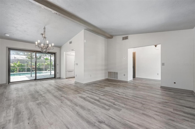 2320 James Ln, Sarasota, FL 34231 - unfurnished living room with a chandelier and wood finished floors