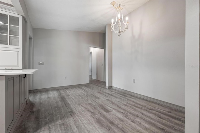 2320 James Ln, Sarasota, FL 34231 - unfurnished dining area with wood finished floors and a chandelier