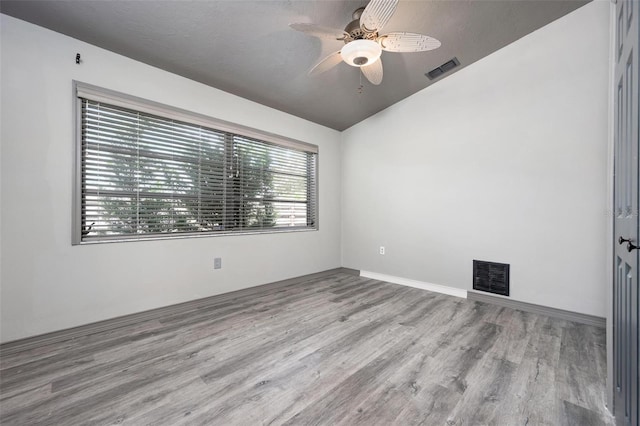 2320 James Ln, Sarasota, FL 34231 - empty room with wood finished floors, vaulted ceiling, and a ceiling fan