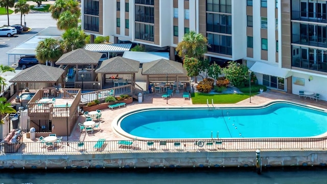 10355 Paradise Blvd Unit 502, Treasure Island, FL 33706 - community pool featuring a patio area