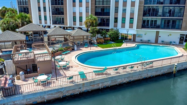 10355 Paradise Blvd Unit 502, Treasure Island, FL 33706 - community pool featuring a patio