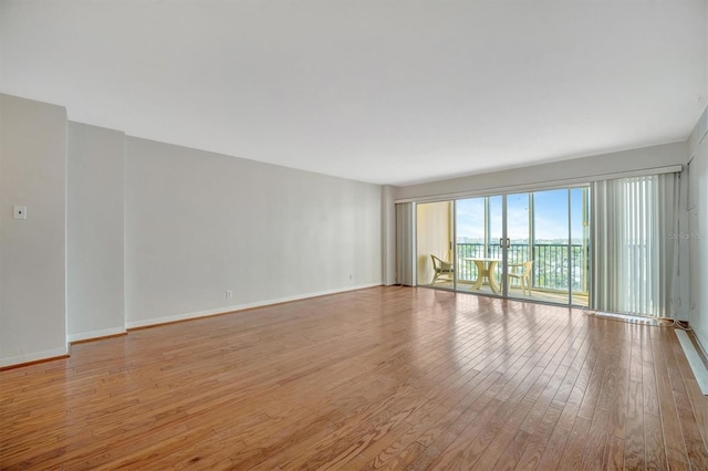 10355 Paradise Blvd Unit 502, Treasure Island, FL 33706 - unfurnished room with hardwood / wood-style floors and baseboards