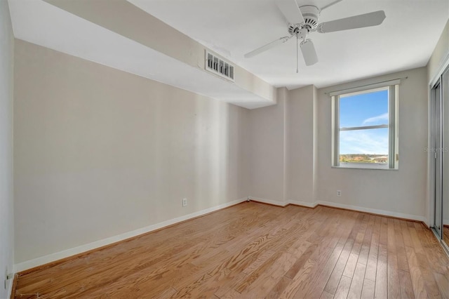 10355 Paradise Blvd Unit 502, Treasure Island, FL 33706 - spare room with hardwood / wood-style floors, a ceiling fan, and baseboards