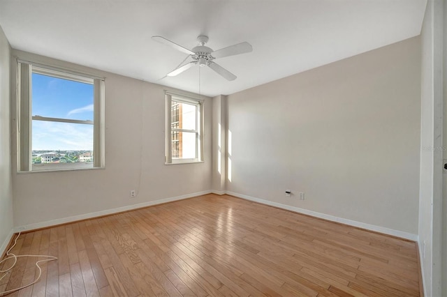 10355 Paradise Blvd Unit 502, Treasure Island, FL 33706 - unfurnished room featuring baseboards, light wood finished floors, and ceiling fan