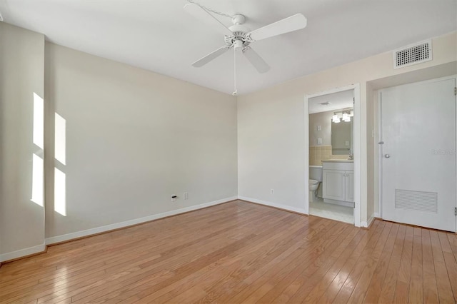 10355 Paradise Blvd Unit 502, Treasure Island, FL 33706 - empty room with light wood-style flooring, a ceiling fan, and baseboards