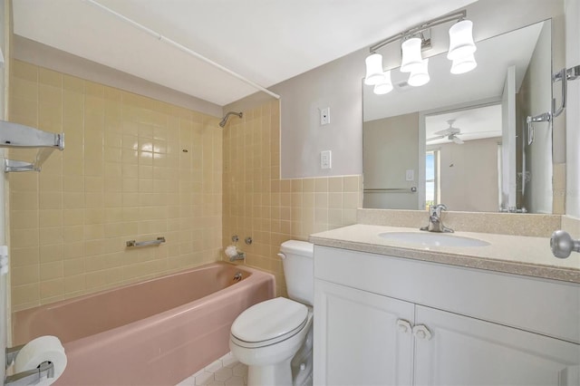 10355 Paradise Blvd Unit 502, Treasure Island, FL 33706 - bathroom with toilet, bathing tub / shower combination, tile walls, ceiling fan, and vanity