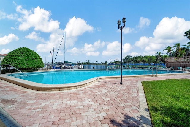 10355 Paradise Blvd Unit 502, Treasure Island, FL 33706 - community pool featuring a patio
