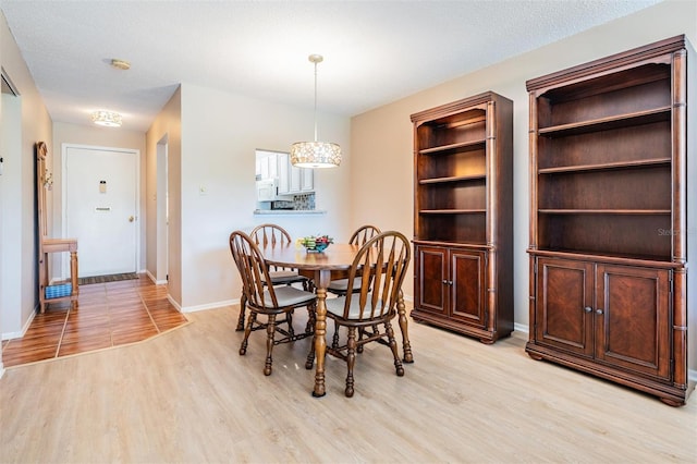 3839 Trophy Blvd Unit 3839, New Port Richey, FL 34655 - dining space featuring light wood-style floors and baseboards