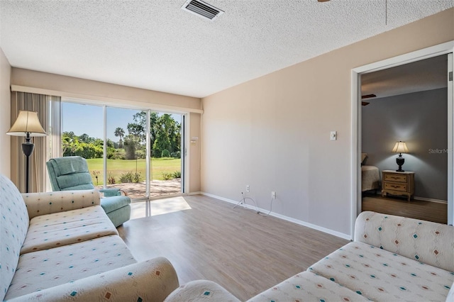 3839 Trophy Blvd Unit 3839, New Port Richey, FL 34655 - living area featuring wood finished floors, baseboards, and a textured ceiling