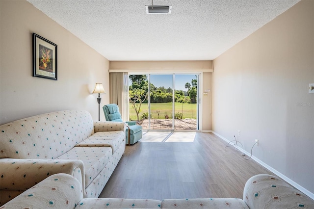 3839 Trophy Blvd Unit 3839, New Port Richey, FL 34655 - living room featuring wood finished floors, baseboards, and a textured ceiling