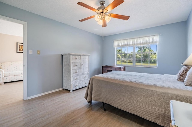 3839 Trophy Blvd Unit 3839, New Port Richey, FL 34655 - bedroom featuring wood finished floors, baseboards, and a ceiling fan