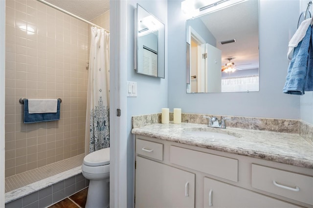 3839 Trophy Blvd Unit 3839, New Port Richey, FL 34655 - bathroom with toilet, vanity, a tile shower, and a ceiling fan
