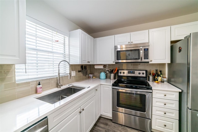 3850 13th Ave N Unit 113, Saint Petersburg, FL 33713 - kitchen with stainless steel appliances, a sink, backsplash, and white cabinets
