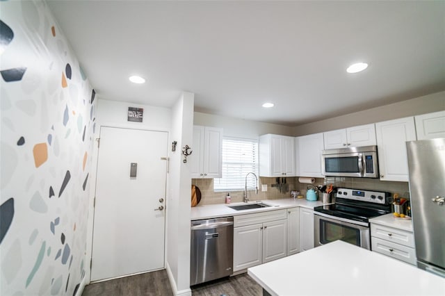 3850 13th Ave N Unit 113, Saint Petersburg, FL 33713 - kitchen with stainless steel appliances, a sink, dark wood-style flooring, light countertops, and recessed lighting