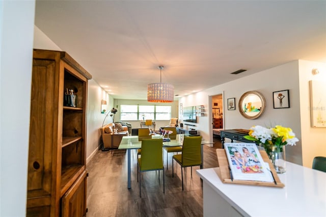 3850 13th Ave N Unit 113, Saint Petersburg, FL 33713 - dining space with a chandelier and dark wood-style floors