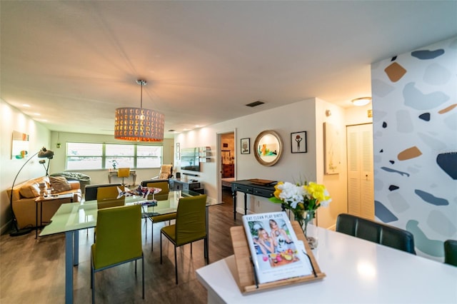3850 13th Ave N Unit 113, Saint Petersburg, FL 33713 - dining area featuring a chandelier and wood finished floors