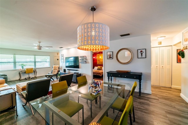 3850 13th Ave N Unit 113, Saint Petersburg, FL 33713 - dining area featuring baseboards, ceiling fan, and wood finished floors
