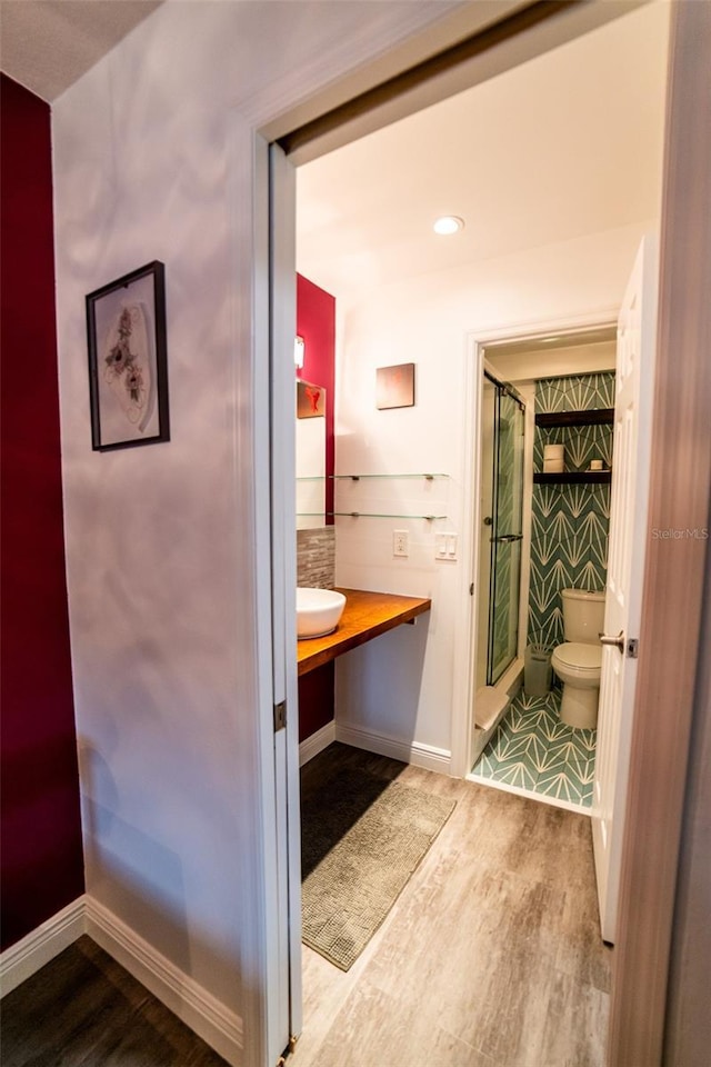 3850 13th Ave N Unit 113, Saint Petersburg, FL 33713 - full bathroom with toilet, a stall shower, wood finished floors, baseboards, and vanity