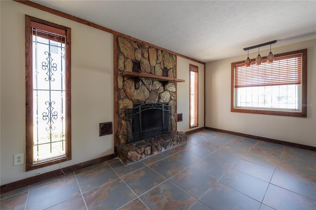 2614 E Liberty St, Tampa, FL 33612 - unfurnished living room with a fireplace, plenty of natural light, and dark tile patterned flooring