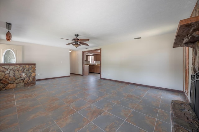 2614 E Liberty St, Tampa, FL 33612 - unfurnished living room with baseboards and ceiling fan