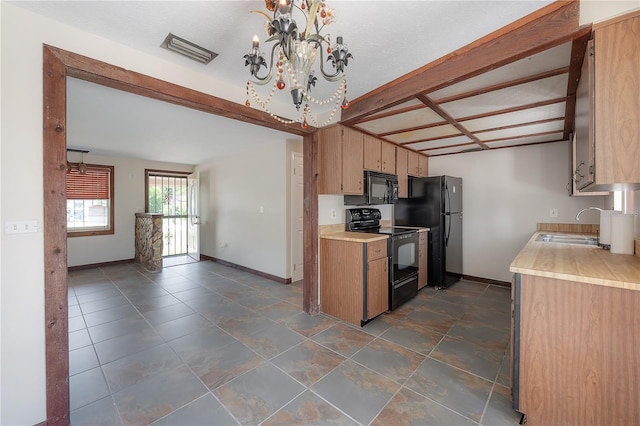 2614 E Liberty St, Tampa, FL 33612 - kitchen featuring black appliances, light countertops, and a chandelier