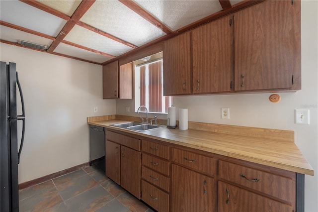 2614 E Liberty St, Tampa, FL 33612 - kitchen with freestanding refrigerator, dishwashing machine, brown cabinetry, and dark stone finish floors