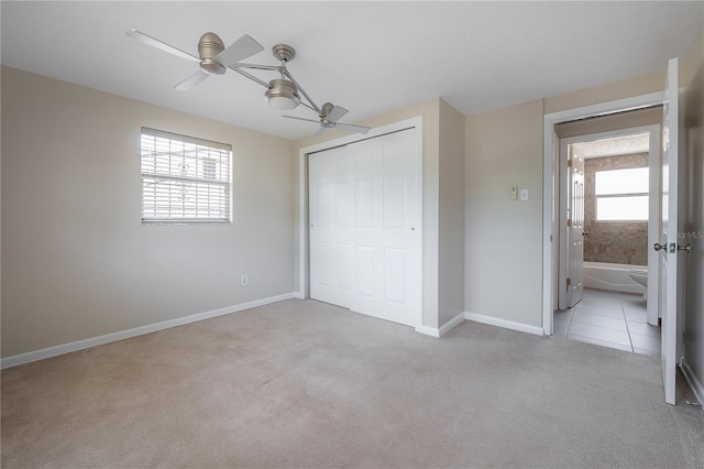 2614 E Liberty St, Tampa, FL 33612 - unfurnished bedroom featuring carpet, a closet, and a ceiling fan