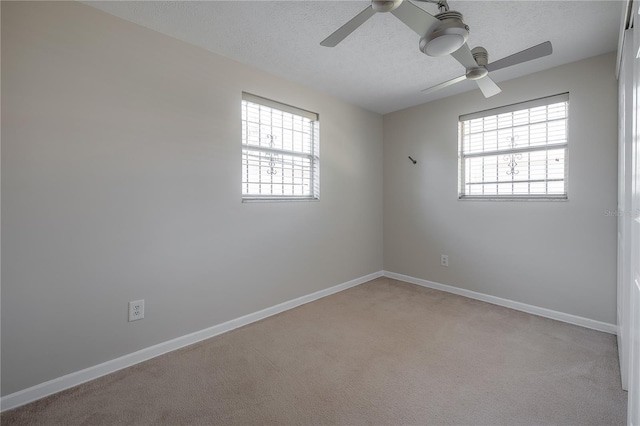 2614 E Liberty St, Tampa, FL 33612 - unfurnished room featuring ceiling fan, healthy amount of natural light, a textured ceiling, and light carpet