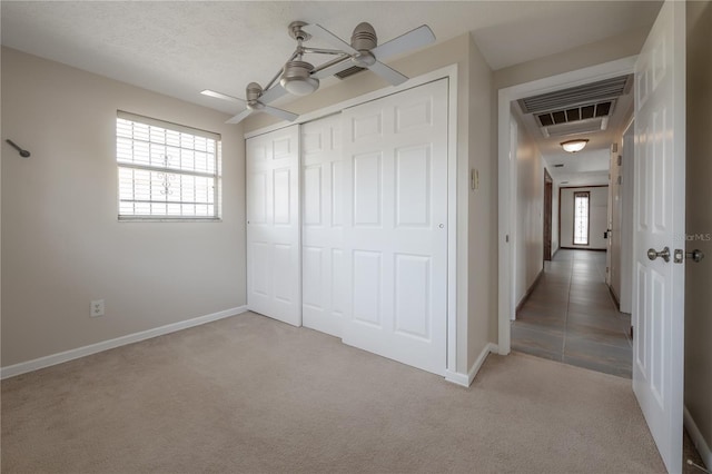 2614 E Liberty St, Tampa, FL 33612 - unfurnished bedroom with light carpet, a closet, and ceiling fan