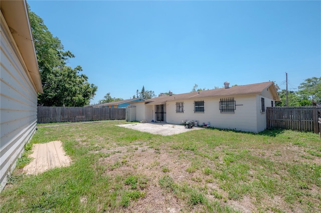 2614 E Liberty St, Tampa, FL 33612 - rear view of property with a patio and a fenced backyard