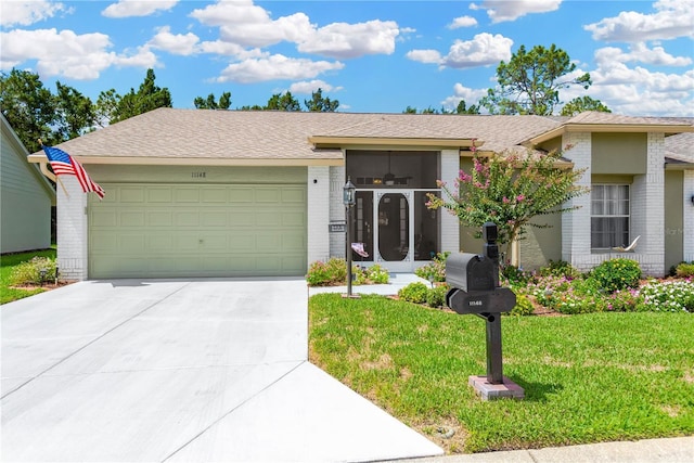11148 Hollander Ave, Hudson, FL 34667 - single story home with brick siding, a garage, a front lawn, and concrete driveway
