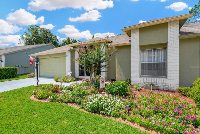 11148 Hollander Ave, Hudson, FL 34667 - view of front facade featuring brick siding, a garage, a front lawn, driveway, and roof with shingles
