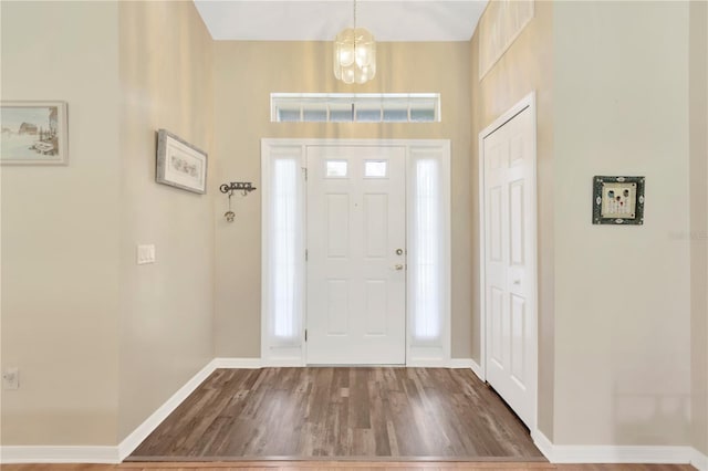 11148 Hollander Ave, Hudson, FL 34667 - foyer featuring wood finished floors, baseboards, and a chandelier