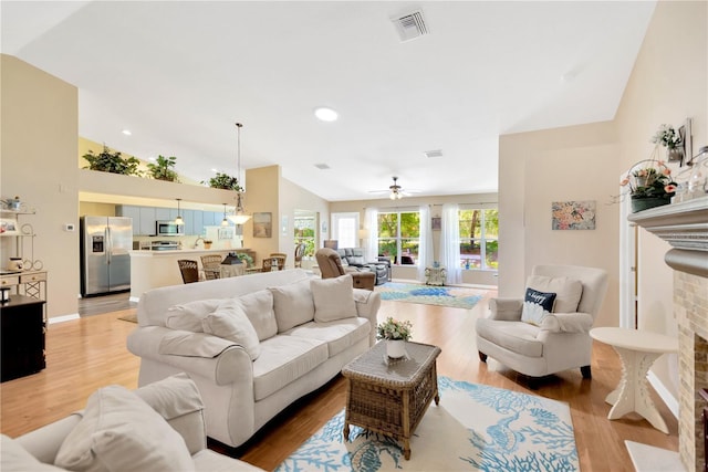 11148 Hollander Ave, Hudson, FL 34667 - living area with vaulted ceiling, light wood finished floors, and ceiling fan