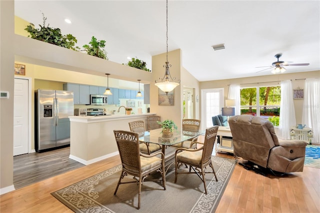 11148 Hollander Ave, Hudson, FL 34667 - dining area with high vaulted ceiling, light wood-type flooring, and ceiling fan