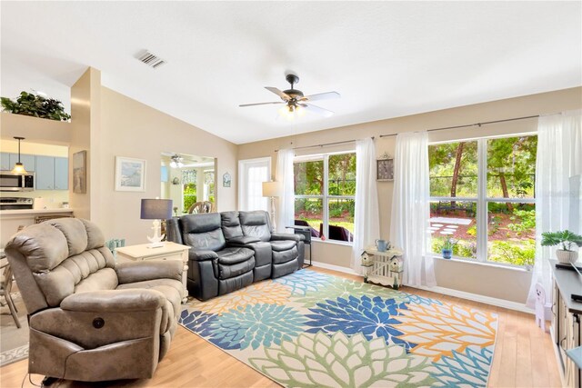 11148 Hollander Ave, Hudson, FL 34667 - living area with ceiling fan, light wood-type flooring, vaulted ceiling, and healthy amount of natural light
