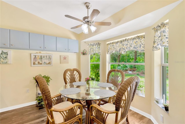 11148 Hollander Ave, Hudson, FL 34667 - dining area featuring light wood finished floors, baseboards, a ceiling fan, and vaulted ceiling