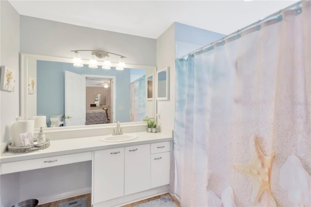 11148 Hollander Ave, Hudson, FL 34667 - ensuite bathroom with ceiling fan, vanity, and curtained shower