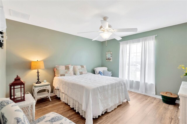 11148 Hollander Ave, Hudson, FL 34667 - bedroom with light wood finished floors, ceiling fan, and baseboards