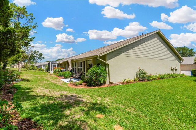 11148 Hollander Ave, Hudson, FL 34667 - view of property exterior with a lawn and stucco siding