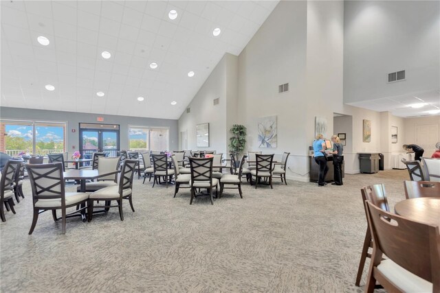 11148 Hollander Ave, Hudson, FL 34667 - dining space featuring carpet flooring, a towering ceiling, recessed lighting, and baseboards
