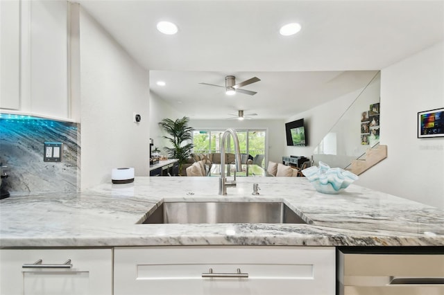 9812 Indian Key Trl Unit 84, Seminole, FL 33776 - kitchen featuring a sink, light stone counters, white cabinets, and recessed lighting
