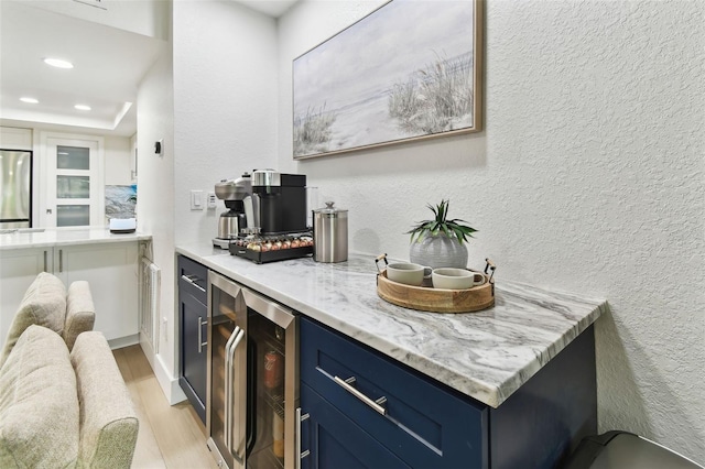 9812 Indian Key Trl Unit 84, Seminole, FL 33776 - indoor dry bar featuring light wood-style flooring, recessed lighting, beverage cooler, freestanding refrigerator, and a textured wall
