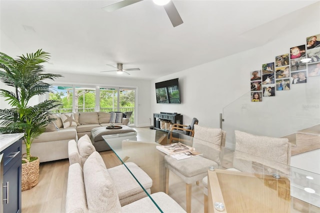 9812 Indian Key Trl Unit 84, Seminole, FL 33776 - living room featuring a ceiling fan and light wood-style floors