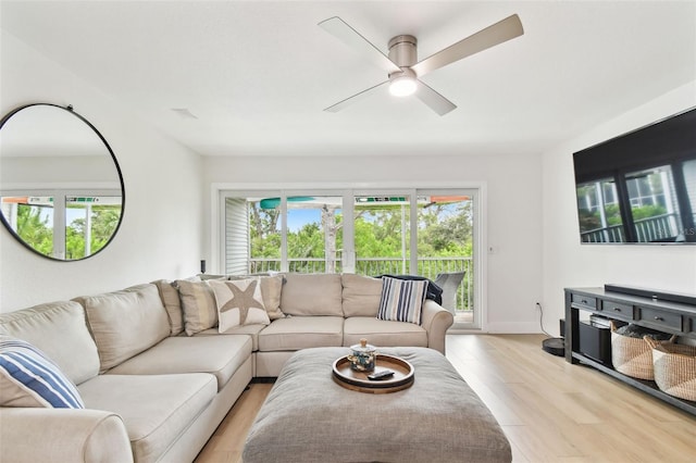 9812 Indian Key Trl Unit 84, Seminole, FL 33776 - living area featuring a ceiling fan, light wood-style floors, and baseboards