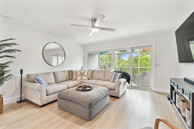 9812 Indian Key Trl Unit 84, Seminole, FL 33776 - living room featuring ceiling fan, light wood-style flooring, and baseboards